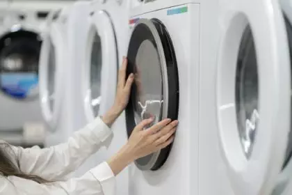a young woman in the store choosing the washing machine